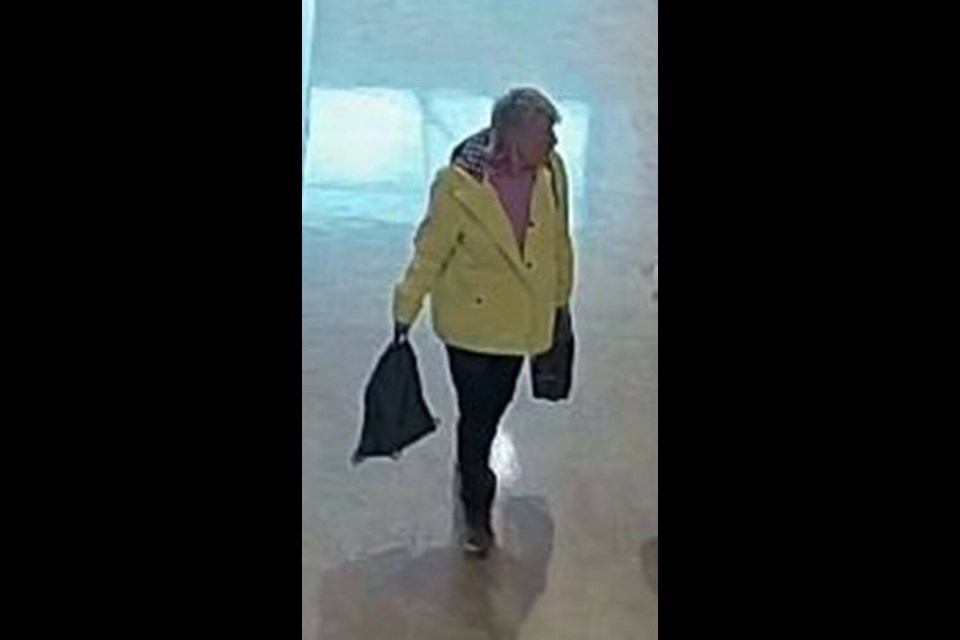 A woman is seen in a surveillance image carrying bags out of Comox Valley Airport. VIA COMOX VALLEY RCMP 