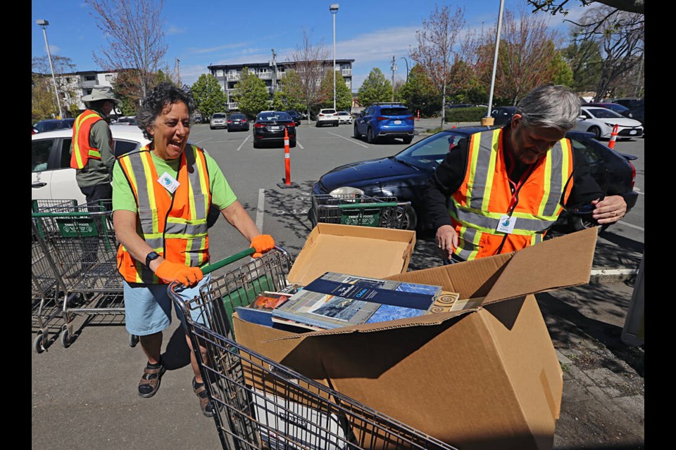 Susan Martin, left, and Chris Coleman help bring in books during the Times Colonist book sale at the Victoria Curling Club in Victoira on Saturday. The drop-off continues Sunday from 9 a.m. to 3:30 p.m. at 1952 Quadra St. ADRIAN LAM, TIMES COLONIST 