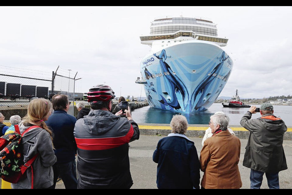 Locals welcome cruise-ship passengers as they disembark from the Norwegian Bliss, the first cruise ship of the season to visit Victoria, at Ogden Point on Wednesday. ADRIAN LAM, TIMES COLONIST 