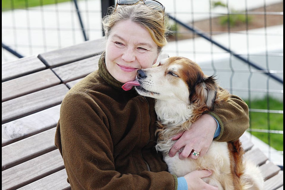 Pauliina Saarinen with her dog Frisky. Saarinen produces a dog calendar as a fundraiser for Operation Freedom Paws Canada. ADRIAN LAM, TC 