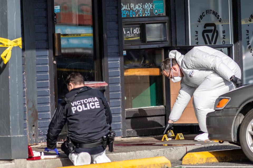 Investigators with VicPD and the Vancouver Island Integrated Major Crime Unit work at the scene of a fatal stabbing at the Douglas Centre Tuesday night. DARREN STONE, TIMES COLONIST 