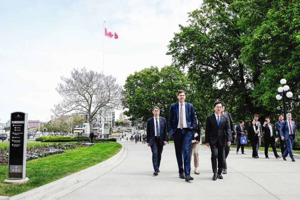 Premier David Eby, centre, walks alongside Governor Kim Dong-yeon, of Gyeonnggi province, right, towards the B.C. Legislature on March 13, 2024. VIA PROVINCE OF BRITISH COLUMBIA/FLICKR 