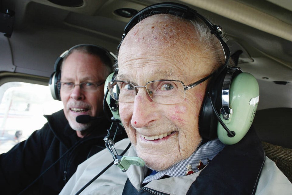 Peter Godwin Chance, 102, was all smiles after Victoria Flying Club instructor Darren Rich, left, handed him the controls in the sky over North Saanich in February 2023. PAUL SEGUNA 