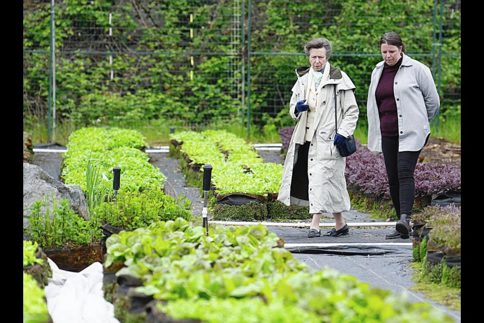 Princess Anne talks on Saturday with Brianna Stewart, managing director of FED, on a tour of the FED Urban Agriculture field. The Victoria-based charity promotes urban agriculture and access to locally grown food. ADRIAN LAM, TIMES COLONIST 