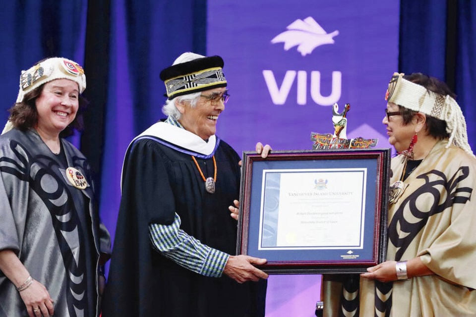 Robert Davidson receives his honorary degree from Vancouver Island University chancellor Judith Sayers on Wednesday, as VIU president and vice-chancellor Dr. Deborah Saucier looks on. 
VANCOUVER ISLAND UNIVERSITY 