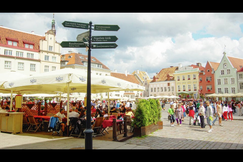 Town Hall Square’s cancan of facades provides a colourful backdrop for markets, performers, and café-goers enjoying inexpensive local beer. RICK STEVES 