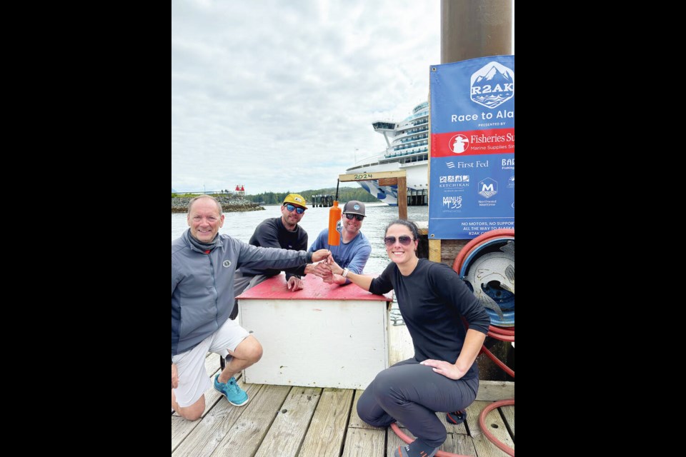 Team Malolo, which includes skipper Duncan Gladman and crew members Matthew Macatee, Paul Gibson and Becky Kelly, celebrates winning the 2024 Race to Alaska. RACHEL BRADLEY 