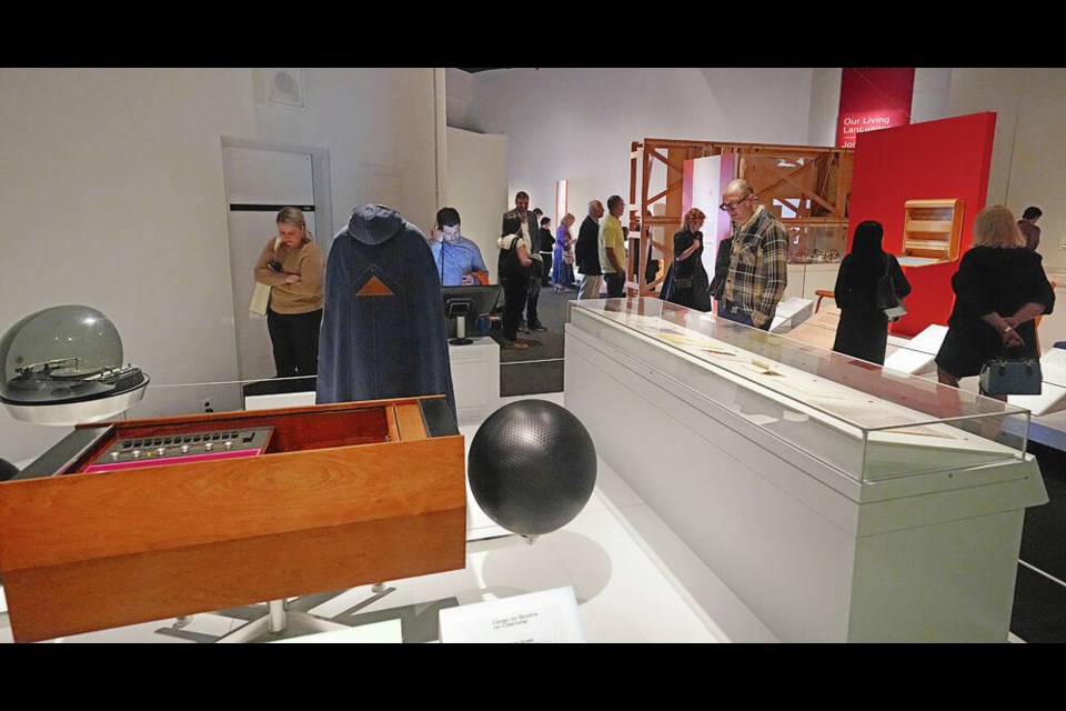 Left: Visitors to the Royal British Columbia Museum take in the displays at the unveiling of Canadian Modern, which features more than 100 culturally significant objects created across Canada. Right: Private collector, curator and writer Allan Collier addresses the crowd. PHOTOS BY ADRIAN LAM, TIMES COLONIST 