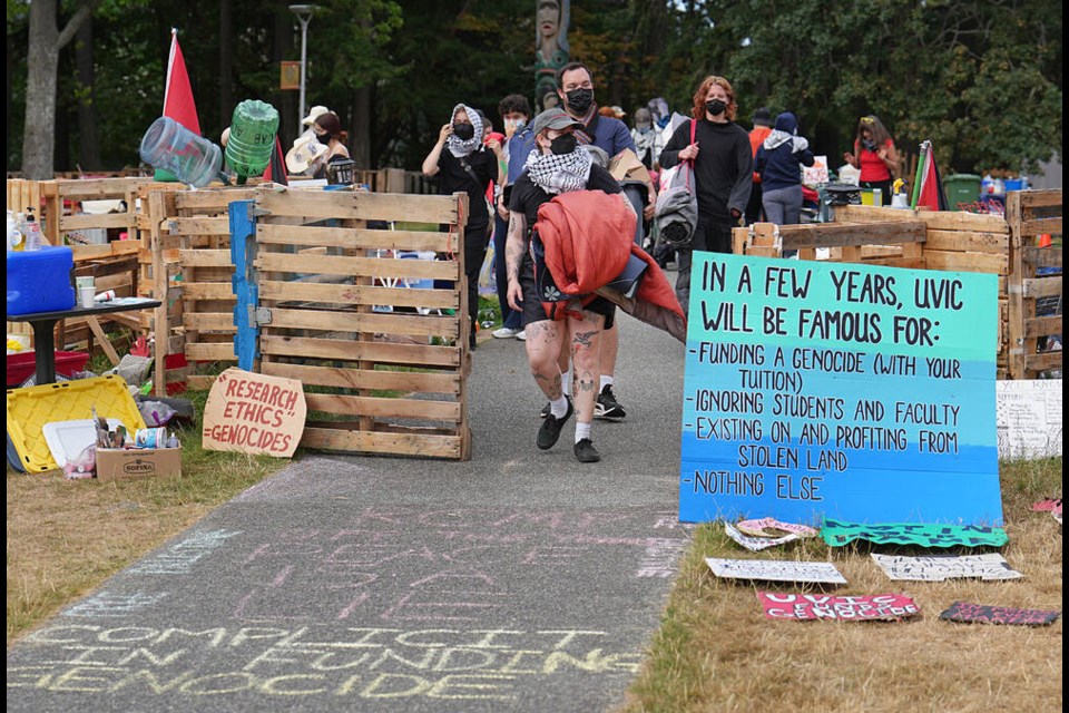 Pro-Palestinian protesters leave the encampment at the University of Victoria on Monday. ADRIAN LAM, TIMES COLONIST 