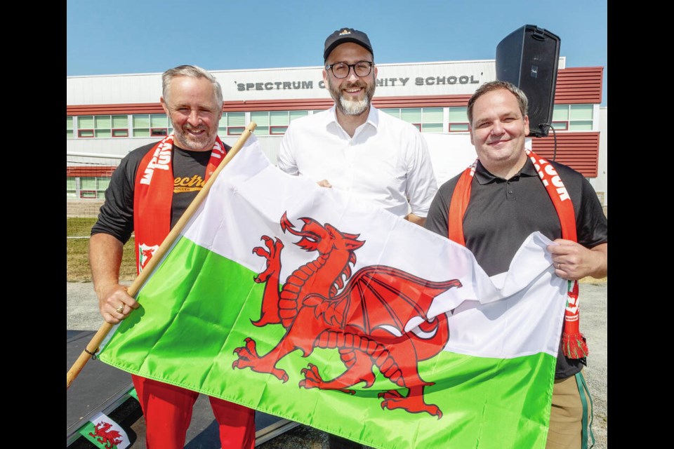 From left, Spectrum Community School athletics director Dominic Butcher, executive director of Wrexham AFC Humphrey Ker, and outgoing principal Bruce Bidney at an event Friday raising awareness of plans for a new field at the school. DARREN STONE, TIMES COLONIST 
