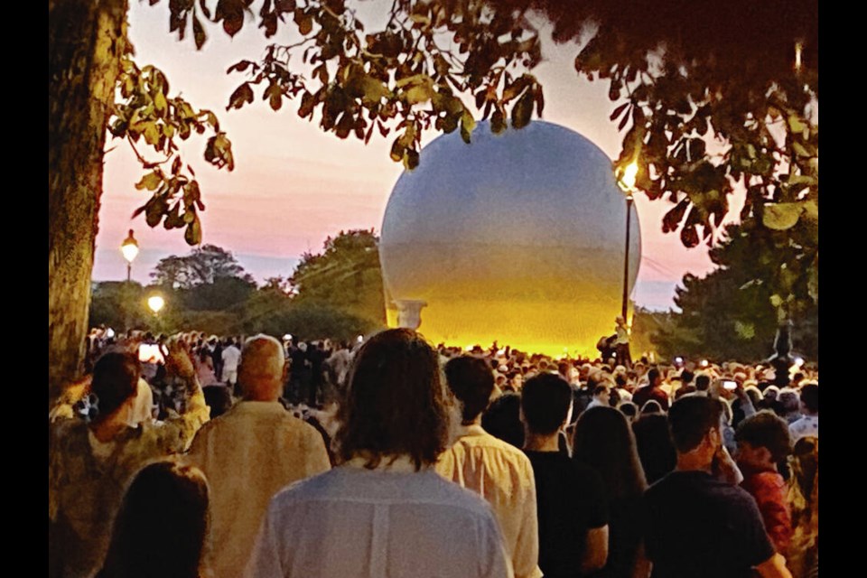 Crowds gathered at sunset every day to prepare to watch the unique Olympic flame, attached to a hot-air balloon, rise over Paris. 
TIMES COLONIST 