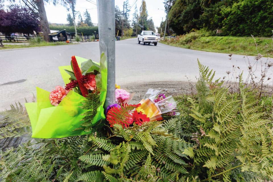 Flowers at the scene of the fatal crash on Central Saanich Road at Tanner Road. DARREN STONE, TIMES COLONIST 