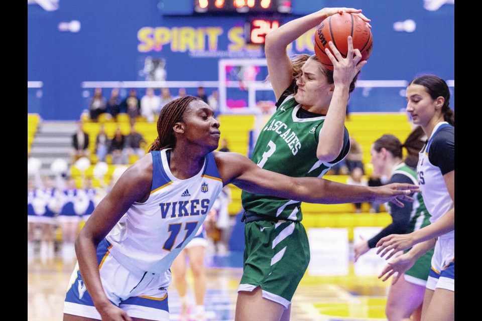 UVic Vikes Mimi Sigue goes for a rebound in front of Fraser Valley Cascades Miah Schuurman in Canada West women’s basketball action at UVic’s CARSA on Saturday. DARREN STONE, TIMES COLONIST 