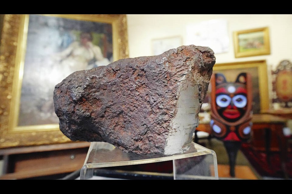 A bowling-ball size meteorite that’s up for bids Dec. 10 at a Lunds Auctioneers & Appraisers auction. ADRIAN LAM, TIMES COLONIST 