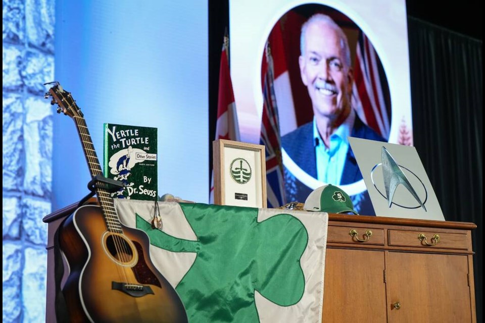 Personal effects are displayed on stage before a state memorial service for former British Columbia premier John Horgan, in Colwood on Sunday. THE CANADIAN PRESS/Darryl Dyck 