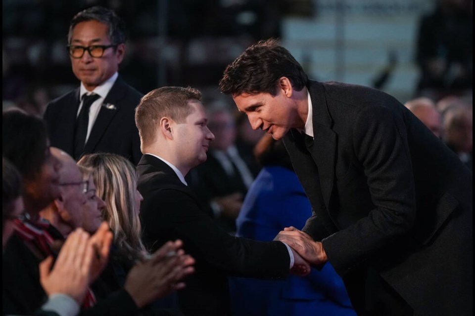 Prime Minister Justin Trudeau shakes hands with former British Columbia premier John Horgan’s son Evan, during a state memorial for Horgan in Colwood on Sunday. THE CANADIAN PRESS/Darryl Dyck 