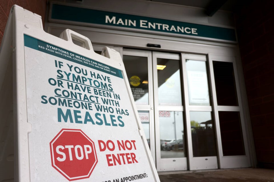 British Columbia's Fraser health authority says the measles infection has been confirmed in three Chilliwack residents since Friday and the cases appear to have been acquired locally. Warning signage for suspected cases of measles is seen outside the main entrance of Woodstock General Hospital in Woodstock, Ont., Thursday, May 22, 2025. THE CANADIAN PRESS/Nicole Osborne