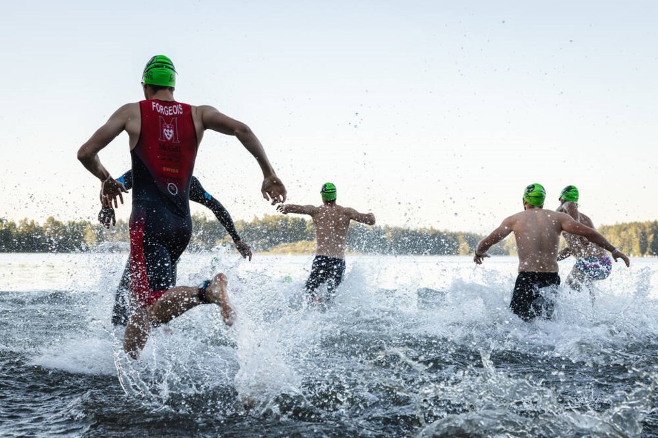 Athletes race into Elk Lake at last year’s triathlon. COURTESY ANGIE WOODHEAD 