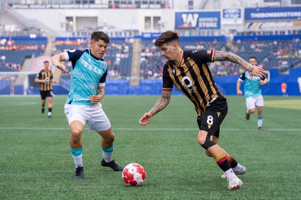 Pacific FC defender Kadin Chung, left, keeps a close eye on Valour FC striker Diogo Ressurreicao during Canadian Premier League action in Winnipeg this month. CAM BARTLETT