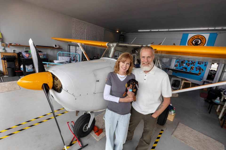 Natalie Foley and Jayson Biggins, who transports wildlife in need in his Cessna 172, with their dog, Luna. DARREN STONE, TIMES COLONIST 