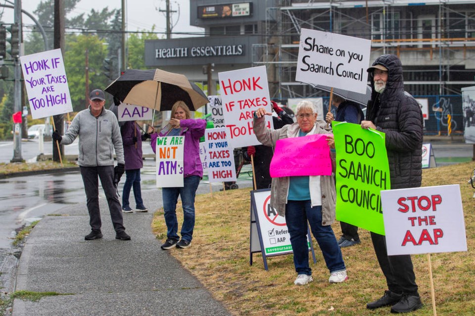 Supporters of the Save Our Saanich Neighbourhoods Society rally at Gorge Road West and Tillicum Road on Saturday, June 21, 2025. The group has mobilized against an alternative approval process would allow the District of Saanich to borrow up to $150 million to redevelop its operations centre at McKenzie Avenue and Borden Street. DARREN STONE, TIMES COLONIST