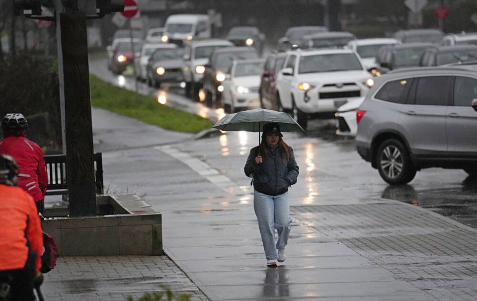 A woman crosses Ravine Way at Blanshard street. ADRIAN LAM, TIMES COLONIST