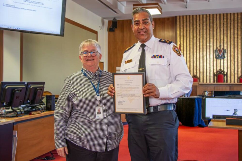 Mayor Marianne Alto and outgoing Victoria Police Chief Del Manak pose for a photo with a commemorative plaque declaring Aug. 27 Del Manak Day. VIA CITY OF VICTORIA