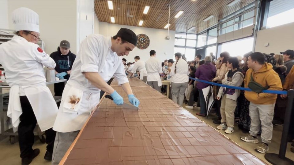 People line up to get a chunk of the world’s largest Nanaimo Bar, created by Vancouver Island University students, staff and alumni. VIA VANCOUVER ISLAND UNIVERSITY