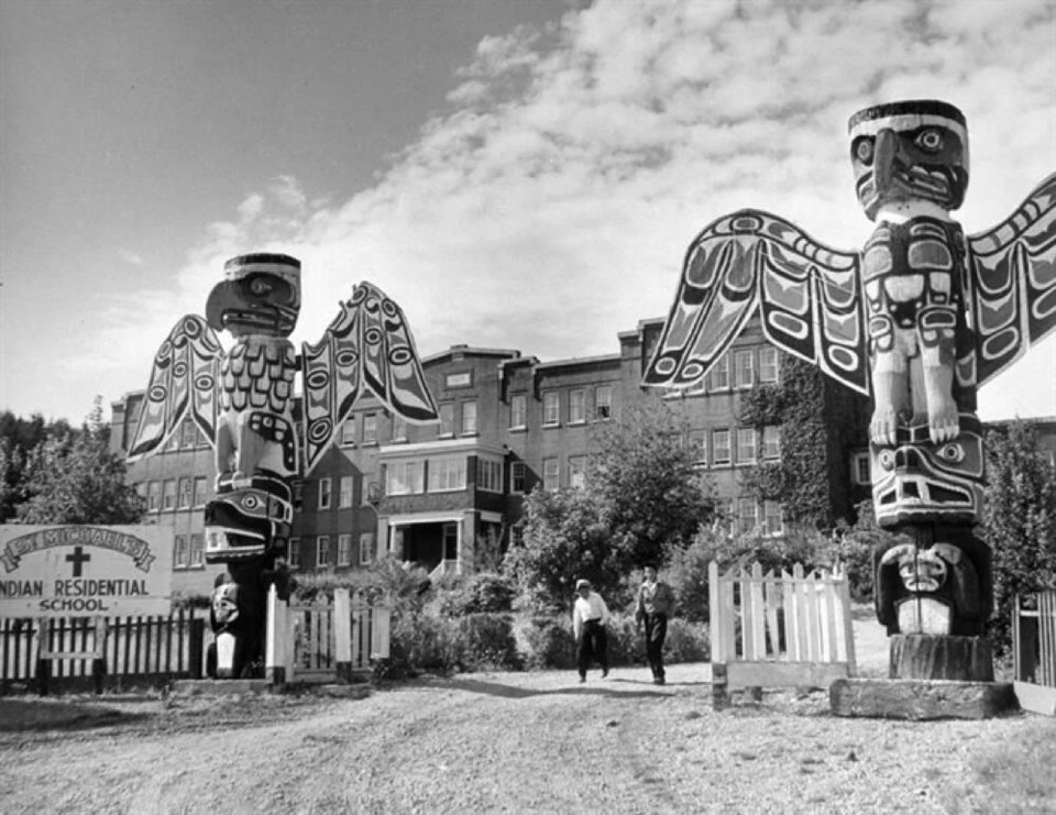 St. Michael’s Indian Residential School entrance at Alert Bay, with two students on the driveway, is shown in a 1970 photo. LIBRARY AND ARCHIVES CANADA