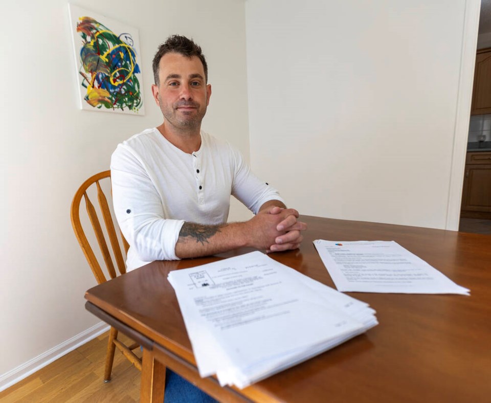Reagan Kutcher-Lang shows documents related to his petition to the Supreme Court of B.C. to order ICBC to pay him past and future lost wages and compensation for a permanent injury. DARREN STONE, TIMES COLONIST