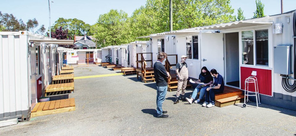 Workers check in a new resident at the tiny home village on Caledonia Avenue. DARREN STONE, TIMES COLONIST