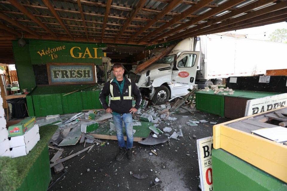 Galey Farms owner Rob Galey stands amid the wreckage after a truck from Golden Valley Eggs slammed into the market building after hitting power poles on Blenkinsop Road on Wednesday morning. No one was injured. Story, A2. DARREN STONE, TIMES COLONIST 