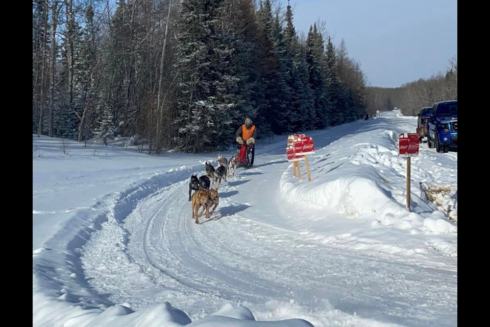 The Knudsen team rounds the turn in the 3-Day World and Manitoba Championship Sled Dog Race.