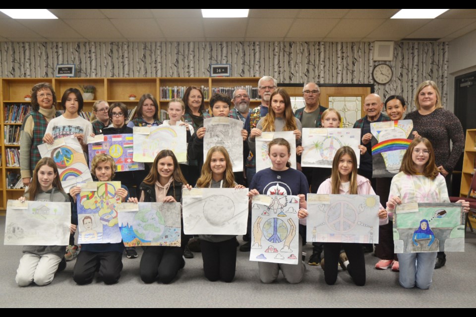 Front Row (l to r): Anna Leask (First Place Winner); Toby Whittle (Second Place Winner), Honourable Mentions: Lucca Wooldridge, Aurora White, Kennedy Sass, Zaree Routledge and Kennedy Routledge. Missing from the photo is Hadley Robertson. Middle row (l to r): Honourable Mentions: Wyatt Merion, Xahder Kotylak, Yardleigh Kenderdine, Sunrise Keewatincappo, Carrie Hodgins, Mason Hay, Shaniene Angeles. Back row (l to r): Lions Joan Veselovsky, Cassandra Hume, Suellen Cocquyt, Judy Cooper, Gordon White, Barry O'Grady, Lloyd Williams (President), and Ben Veselovsky; Tracy Ramsey, Principal, Virden Junior High School. 