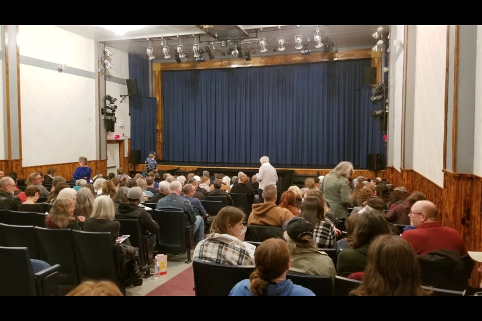The Bend Theatre in Strathclair, Manitoba is filling up, patrons take time to read their programs and get some popcorn before they settle in for the feature length stage production, the Adams Family.