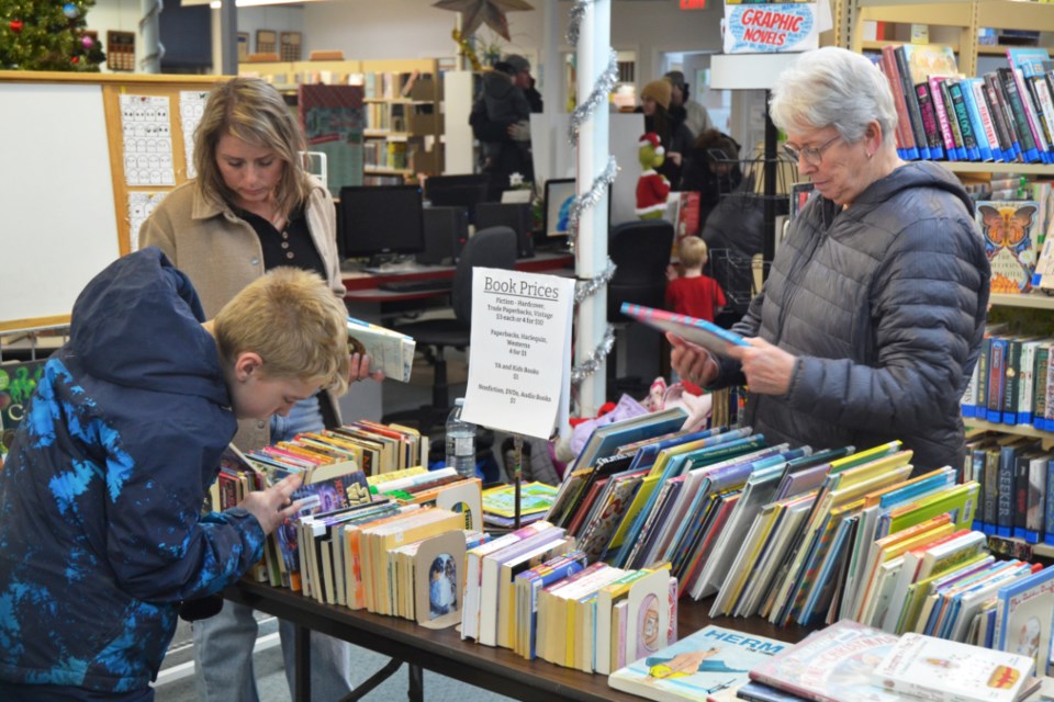 Visitors look through the literature on offer during the Plaid Friday Book Sale at the Virden Border Regional Library on Light-Up Night, Nov. 23. The sale extended through to Saturday, raising funds for the library. 