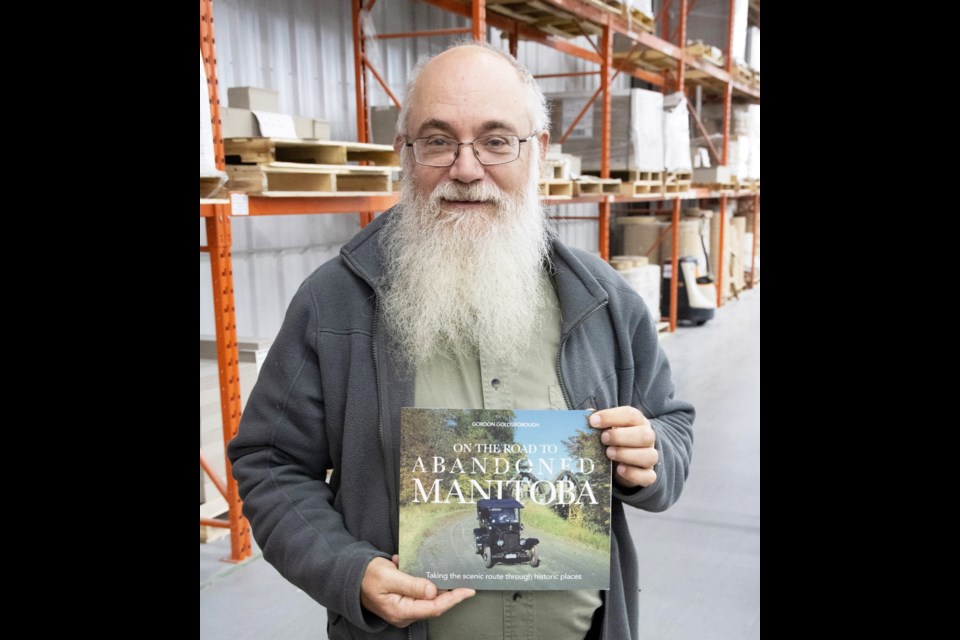 Goldsborough holds his latest book On the Road To Abandoned Manitoba.