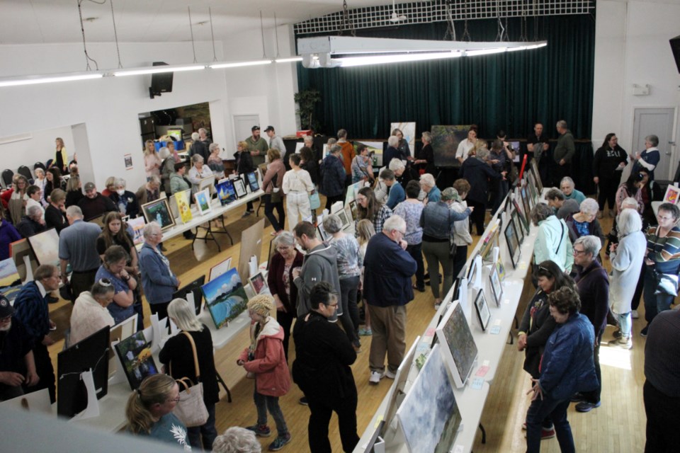 Kenton Community Hall is buzzing with interest in the 104 pieces of art on display, April 28.