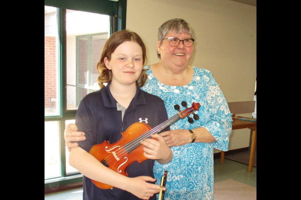 President of the Southwest Assiniboine Chapter of the Retired Teachers Association of Manitoba, Lorraine Scott expresses appreciation for violinist Riley Jorgensen who entertained at the retired teachers meeting in April of 2019.