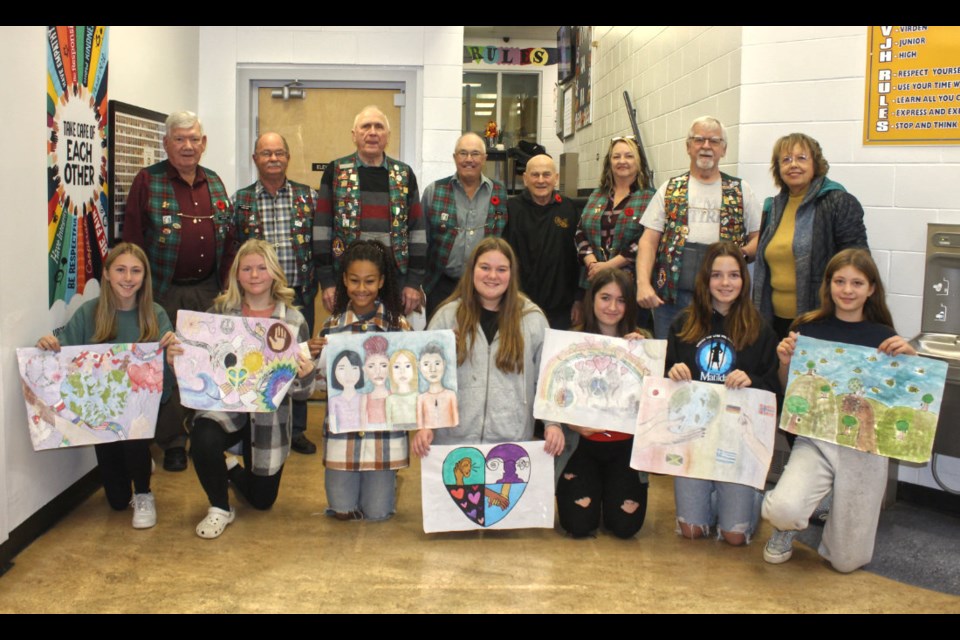 Prize winners are: (l-r) Michelle Watters, Jael Forbes, Kelis Hunter, Kelsey Studer, Rylee Roberts, Scotlyn Chadney, and Kenzie Hayden. Michelle Watters's poster will go on to further competition.
Lions attending (rear): (l-r) Marcel Chacun, Gerald Ogilvie, Alex Sundell, President Lloyd Williams, Ben Veselovsky, Judy Cooper, Barry O'Grady, and Joan Veselovsky. 