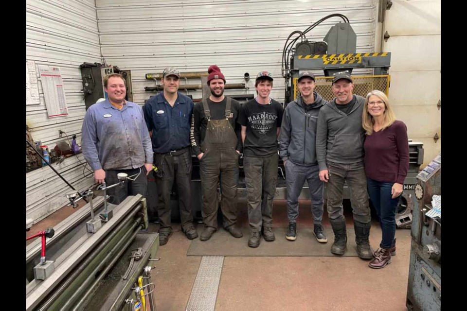 Tyson Van Eaton, Ian Gibbons, Riley Boles, Evan Eikanger, Jared Davies, Murray, and Joyce Davies in December 2021. PHOTO/Trans Canada Bearing & Machine