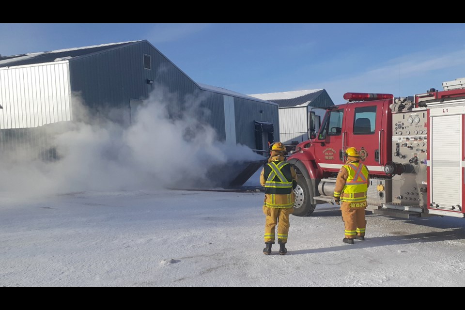 Wallace District Fire Department  attends to the rear of the former Virden re-cycle depot to deal with a smoldering dumpster .
