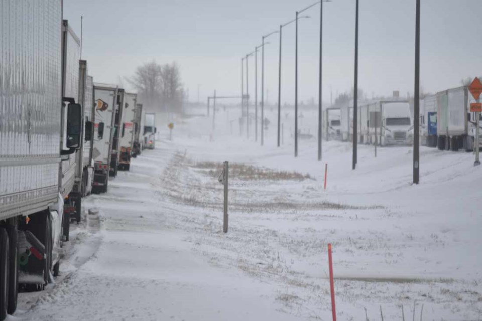A spring storm which began as rain last Saturday turned to snow at night, and the slippery, blustery conditions necessitated the closure of the Trans-Canada Highway to the Saskatchewan border during the weekend.  The result was an all-too-familiar sight this winter, dozens of semi-trucks stacked up for miles as their drivers waited to resume their journey.    