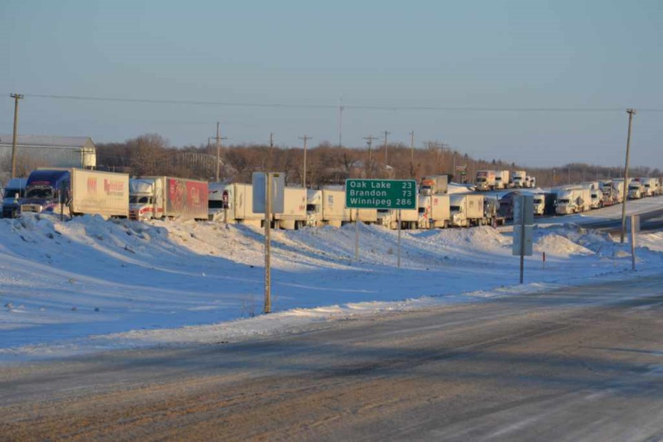 Dozens of transport trucks fill the eastbound and westbound lanes of the Trans-Canada Highway through Virden on Feb. 23. The thoroughfare was closed in both directions from the Manitoba-Saskatchewan border to Brandon due to icy conditions. Accommodation at hotels along the service road was quickly snapped up, and the Westman Emergency Group opened a reception centre and lodged stranded travellers at Tundra Oil & Gas Place for the night.  