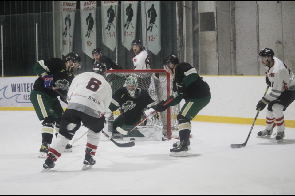 In white jerseys, the Miniota-Elkhorn C-Hawks defeat the Killarney Shamrocks 5-3 in this game in Elkhorn arena.