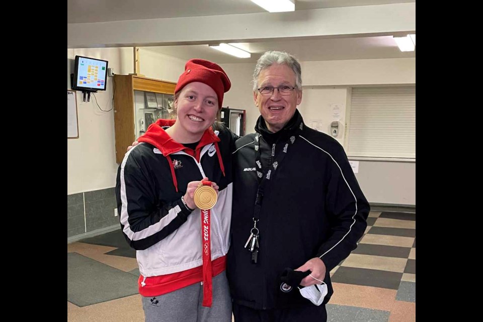 Ashton Bell with her Team Canada gold medal at Deloraine breakfast club skate, with her former coach Bob Caldwell.
