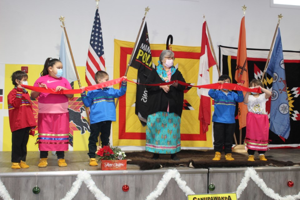 Fort La Bosse division teacher and Canupawakpa community elder Linda Eastman is about to snip the ribbon.