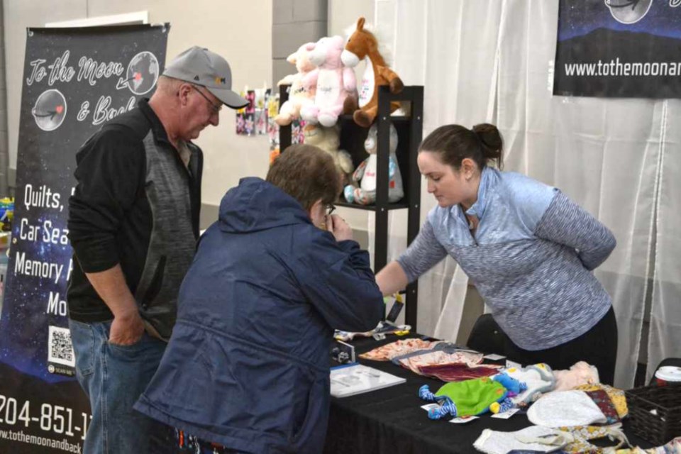Organizer Bree Kyle serves customers at her table during the Virden Small Business, Craft & Trade Show at the Legion Hall on Sunday, May 1.  20 exhibitors displayed and sold their wares during the afternoon.  