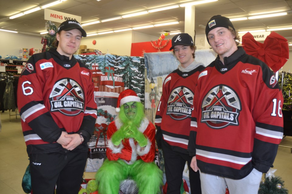 Local Virden Oil Capitals players Ty Plaisier, left, Eric Reid and Grady Lane came out to support "Fill a Sleigh Day," greeting customers and helping out where needed. Rhylan Baxter and Luke Robson also took their turn during the afternoon.