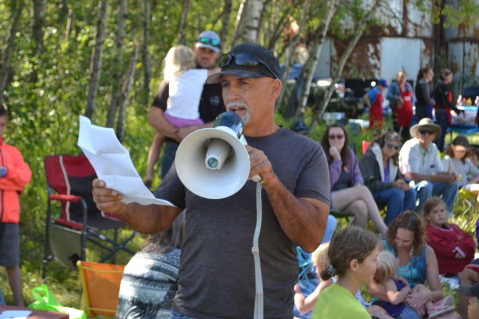 Don Neufeld, organizer of the Crossborders Growing Project adresses the crowd gathered for the harvest barbecue on Friday, Sept. 9.